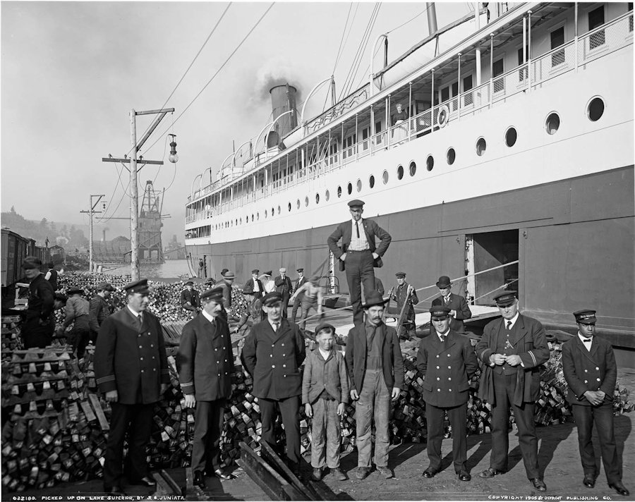 Two survivors John Ruskin and his son with the officers of the steamer 'Juniata,' who rescued them from their capsized skiff during a storm on Lake Superior, Houghton Harbor, MI, September 28, 1905, from Detroit Publishing Co., via Library of Congress.